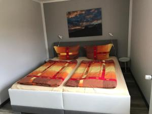 科尔斯万特Ferienwohnung Lorenz的客房内的一张带两个枕头的白色床