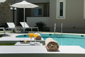 基萨莫斯Limosa Luxury Residences的一张桌子,旁边是两杯酒,