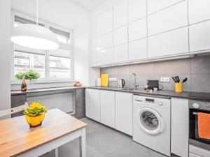 波兹南Best INN Poznań Apartament Orzeszkowej的厨房配有洗衣机和桌子