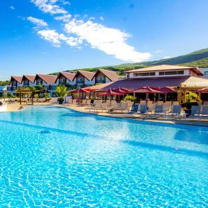 拉萨尔勒班阿呼弥Spa酒店的度假村内带椅子的大型游泳池