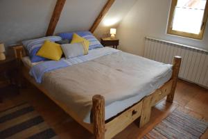 马考巴尔贾Kuća za odmor Mećava的一间卧室配有蓝色和黄色枕头的床