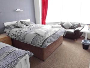 布里德灵顿茉莉花宾馆的一间卧室配有一张床和一张沙发
