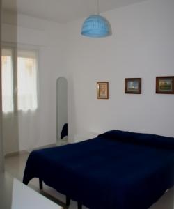 迪亚诺马里纳Residenza Abbo的一间卧室配有蓝色的床和一盏灯