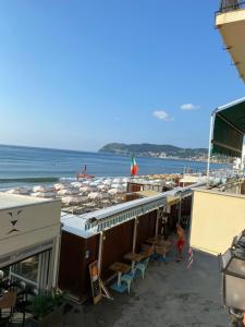 阿拉西奥appartamento fronte mare con terrazzo的享有海滩美景,配有遮阳伞和海洋美景。