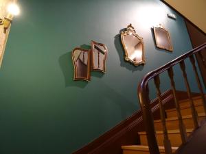 波尔图GuestReady - Belle Epoque Apartmento - 3.1的绿色墙上的三面镜子楼梯