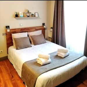 波城甘贝塔公寓的一间卧室配有一张床,上面有两条毛巾