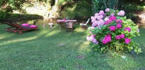 KrašićMobile home Camp vikendica Slapnica u Parku prirode Žumberak i Samoborsko gorje的花园配有桌椅和鲜花