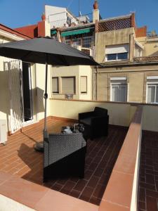 巴塞罗那巴塞罗那公寓 - 伊比利亚的阳台的遮阳伞、桌子和椅子