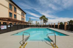 拉斯维加斯拉斯维加斯机场南拉昆塔套房酒店的一座拥有棕榈树的建筑中的游泳池