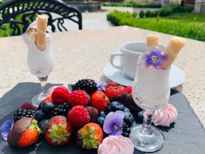 PolednoHotel Pałac Poledno的桌上的两杯冰淇淋和水果