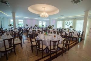 马佐夫舍地区格罗济斯克Hotel Grodzisko的宴会厅配有白色的桌椅