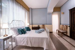 卡利亚里Palazzo Chiara的一间卧室配有白色床和蓝色枕头