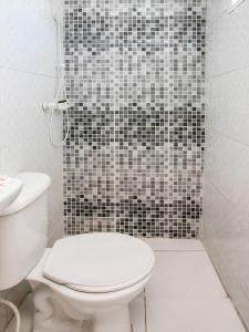 圣保罗OYO Hotel Vintage, São Paulo的浴室设有卫生间和黑色及白色瓷砖淋浴。