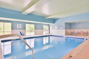 塞勒姆塞勒姆智选假日酒店 的一个带蓝色墙壁的游泳池和一间大房间
