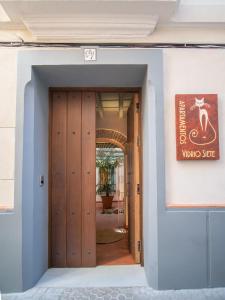 塞维利亚Casas de Sevilla - Apartamentos Vidrio 7的通往带木门的大楼的门