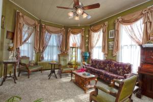 FairfieldThe Victorian on Main的客厅配有沙发、椅子和吊扇