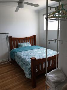 珀斯DIANELLA Budget Rooms Happy Place to Stay & House Share For Long Term Tenants的一间卧室配有双层床和吊扇