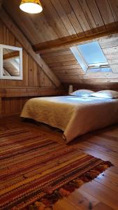 萨尔拉拉卡内达Domaine de la Queyrie的木制客房的一张床位,设有窗户
