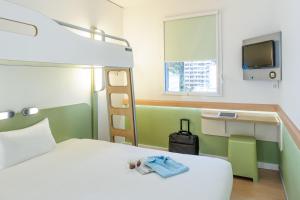 卢加诺卢加诺天堂宜必思快捷酒店的一间酒店客房,配有一张床和一台电视
