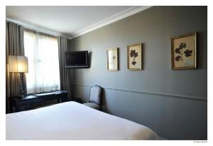 里尔德拉特尔伊酒店的一间卧室配有一张床,墙上配有电视