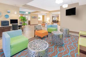 米德韦斯特城La Quinta by Wyndham Midwest City - Tinker AFB的医院的大厅,有五颜六色的椅子和桌子