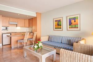 塔乌里托Hotel LIVVO Lago Taurito & Aquapark的客厅配有沙发和桌子
