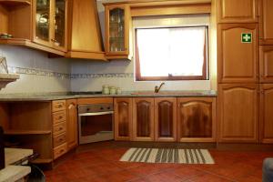 布拉加Quinta Santo António Amares的厨房配有木制橱柜和窗户。