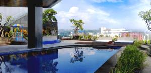 三宝垄PO Hotel Semarang的建筑物屋顶上的游泳池