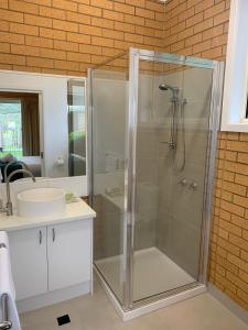坎贝尔港坎贝尔汽车旅馆公寓的一间带玻璃淋浴间和水槽的浴室