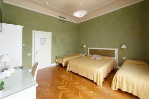 利沃诺杰那利诺酒店的绿墙客房内的两张床
