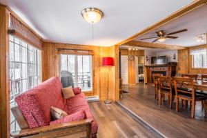Saint-Tite-des-Caps卢克圣提特轻松木屋的带沙发的客厅和用餐室