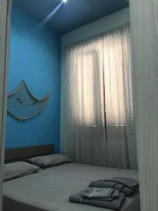 玛格丽塔萨沃亚Salinis Apartments的一间卧室配有床和带毛巾的窗户。