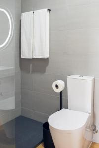 普拉亚达维多利亚Hostel da Palmeira的浴室设有白色的卫生间和镜子