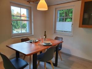 蒂蒂湖-新城Apartment Happy Memories的餐桌、椅子和一瓶葡萄酒