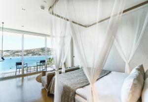 京多安Cape Bodrum Luxury Hotel & Beach的一间卧室配有一张床,享有海景