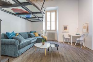 罗马Casa Manara in Trastevere的客厅配有蓝色的沙发和桌子