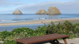 新港夏季风经济汽车旅馆的木凳坐在海滩上,在水中岩石