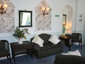 法尔茅斯Rosemullion Hotel的客厅配有沙发、椅子和镜子
