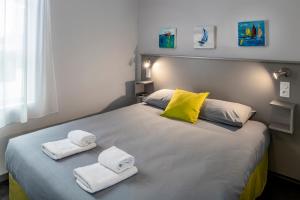 圣纳泽尔SmartAppart Saint Nazaire的一间卧室配有带毛巾的床