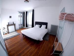 ToucyLa Maison d'hotes de Toucy的卧室配有白色的床和木地板
