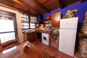 HinojaresApartamentos La Suerte的厨房配有冰箱和洗衣机。