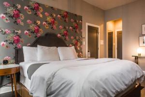芝加哥柳条公园酒店的卧室配有一张墙上鲜花的大床
