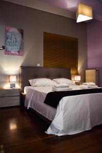 雅典Βright Walled Designed Apt in Glyfada Center的酒店客房,配有两张带白色床单的床