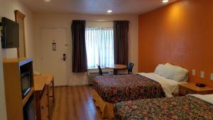 阿拉米达Rodeway Inn Alameda-Oakland的酒店客房设有两张床和电视。