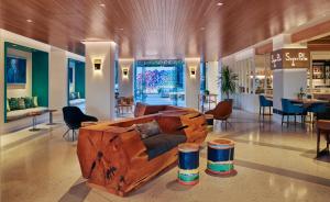 洛杉矶圣莫尼卡总督酒店的中间设有带木制沙发的客厅