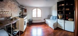 卡拉拉STUPENDA MANSARDA CENTRALISSIMA, finiture di lusso的厨房和带沙发的客厅,铺有木地板。