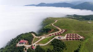 里泽Flora Handüzü Resort Bungalow的云层背景的高山空中景观