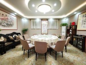 济宁锦江之星品尚济宁曲阜景区鼓楼北街酒店的一间配备有白色桌椅的用餐室