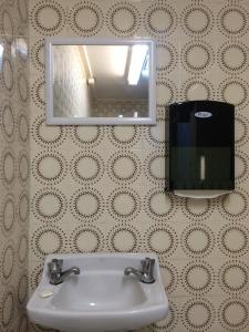 悉尼中央私人酒店的浴室设有盥洗盆、镜子和肥皂机
