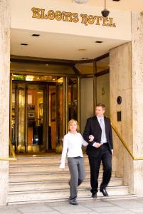 都柏林布鲁姆斯酒店的男人和女人走在建筑物的台阶上